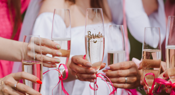 a close up shot of bridesmaids holding champagne